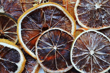 Fototapeta na wymiar Natural background of round dry slices of red grapefruit or lemon