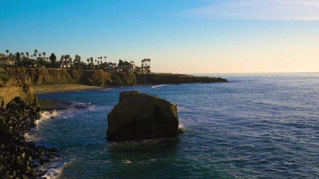 Ocean coastline houses along rocky sunset cliffs in beautiful southern California