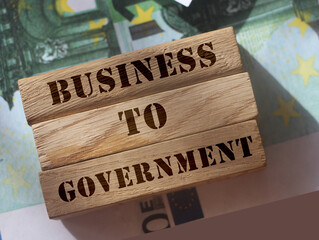 Business to Government B2G on Wooden Blocks put on hundred Euro bills Representing Business 2...
