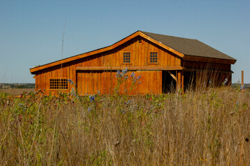 old red barn in a prarie