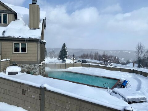 Outdoor Swimming Pool At Okemo Mountain Ski Resort With Fresh Snow In Vermont USA