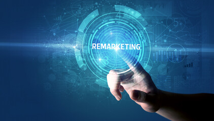 Hand touching REMARKETING button, modern business technology concept