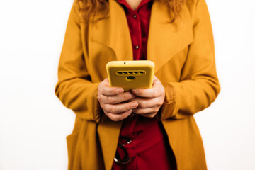 Closeup shot of a female holding her smartphone on an isolated white background. selective focus.