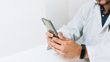 hands of a doctor or dentist, holding a phone. online communication concept.