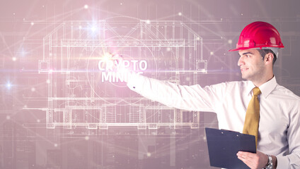 Handsome architect with helmet drawing CRYPTO MINING inscription, new technology concept