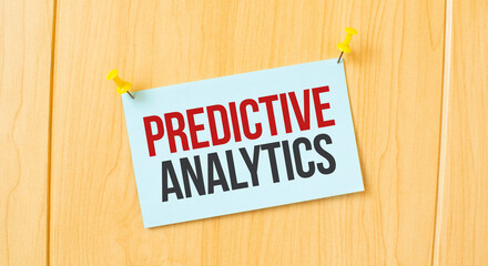 PREDICTIVE ANALYTICS sign written on sticky note pinned on wooden wall