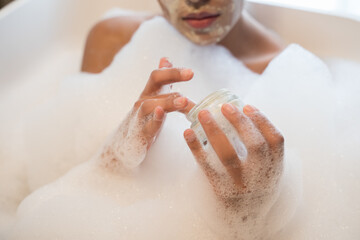 Female leaning on side of bath while resting there
