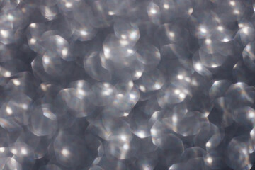 abstract silver background bokeh. sparkles of silver glitter. elegant silver backdrop.