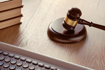 Law hammer, computer keyboard and stack of books. Concept of legal advice, consultation, counseling...