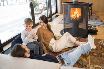 Family warming near the fireplace