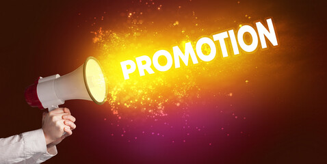 Young woman yelling to loudspeaker with PROMOTION inscription, modern media concept
