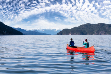 Couple friends canoeing on a wooden canoe during a sunny day. Colorful Sky Art Render. Taken in...
