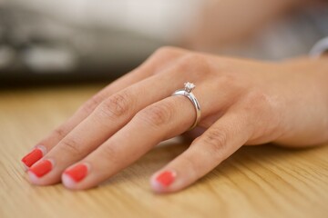 Woman hand wearing an engagement ring