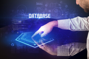 Hand touching digital table with DATABASE inscription, new age security concept