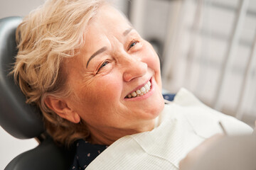 Patient sitting at the dentist chair and smiling