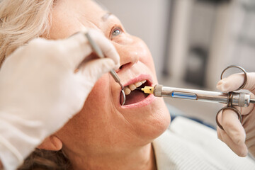 Woan getting local anesthesia injection into gums