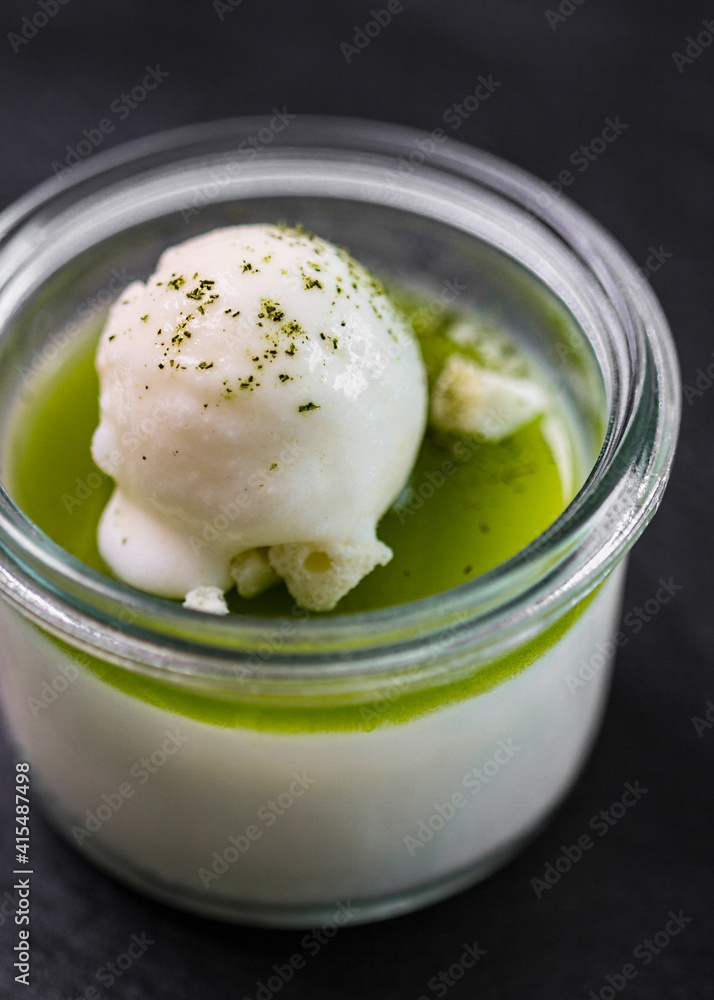 Sticker Vertical shot of ice cream with pistachio in a glass on the table