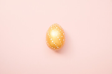 Easter golden decorated eggon pastel pink background. Minimal easter concept. Happy Easter card with copy space for text. Top view, flatlay. Concept for banner, flyer, invitation, greeting card