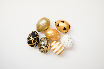 Easter golden decorated eggs isolated on white background. Minimal easter concept. Happy Easter card with copy space for text. Top view, flatlay