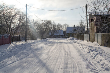 Long village road covered with snow in Belarus