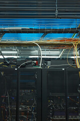 Vertical background image of server cabinet with cables and wires in data center, supercomputer concept, copy space