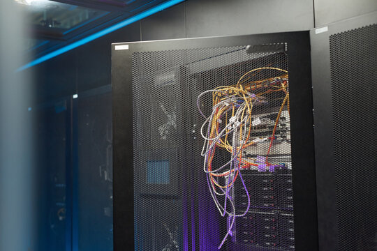 Background image of server cabinet with cables and wires in data center, supercomputer network concept, copy space