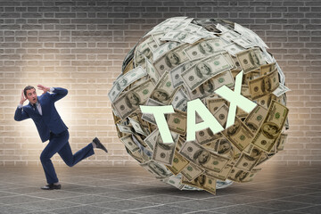 Businessman running away in tax concept