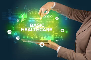 Close-up of a touchscreen with BASIC HEALTHCARE inscription, medical concept