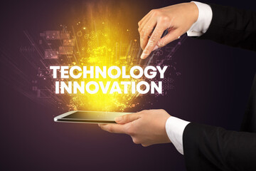 Close-up of a touchscreen with TECHNOLOGY INNOVATION inscription, innovative technology concept
