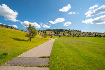 Fototapeta na wymiar A wide community park and lawn in a new home, hillside subdivision outside of Spokane Washington, USA