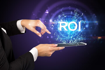 Close-up of a touchscreen with ROI abbreviation, modern technology concept