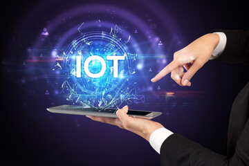 Close-up of a touchscreen with IOT abbreviation, modern technology concept