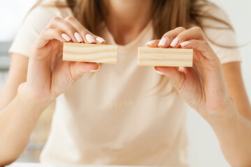 Hand putting and stacking blank wooden cubes on table with copy space for input wording and...