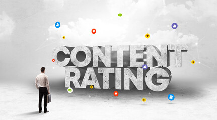 Young businessman standing in front of CONTENT RATING inscription, social media concept
