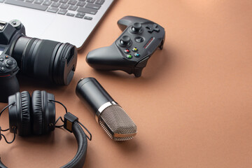 Camera, joystick or gamepad, headphones, microphone and laptop, top view. Modeling and blogging, broadcasting games and donation. With space for inscription