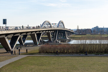Dresden spring season at the Waldschlösschen Bridge. A lot of people are walking around at the Elbe river banks and enjoying the nature.