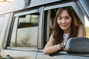 Asian women are happy to drive a camping trip on vacation,Journey concept