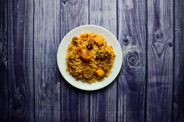 Karachi Chicken Biryani with Potatoes made in Sella rice in White Plate