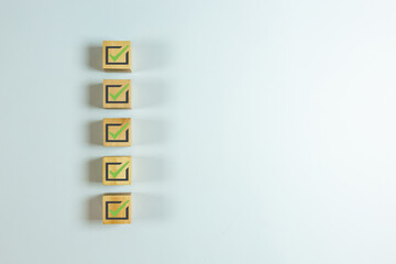 Wood cube with check mark on white background, Checklist concept, Copy space.