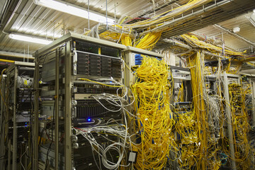 Background image of messy server room with internet cables and wires, copy space