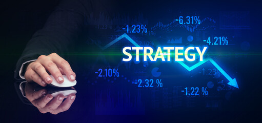 male hand holding wireless peripheral with STRATEGY inscription, modern business concept