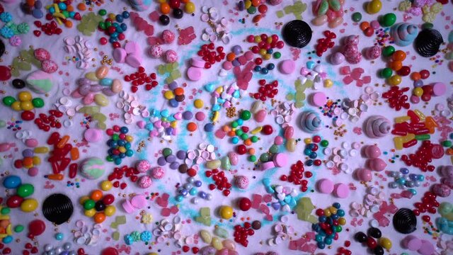 Confectionerâ€™s close up of jelly beans, colorful chocolate coated candy, various flavours mixed sweets, marshmallow, snack, caramels, swirls, sugar and cake sprinkles. Candy land explosion dream.