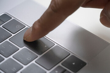 Male hands typing on keyboard on laptop, fingers pressing keyboard, personal computer, blind touch