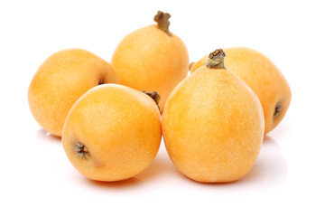 Close up view of some loquat fruit isolated on a white background 