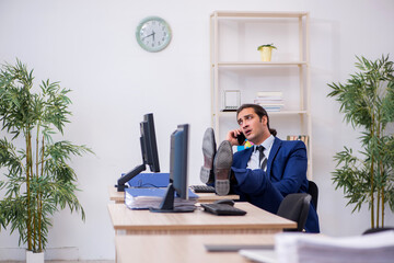 Young male employee working in the office