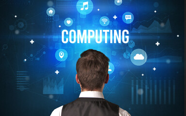 Rear view of a businessman with COMPUTING inscription, modern technology concept