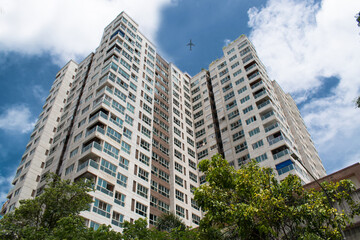 Plane flying above skyscraper building from centre .Bottom view