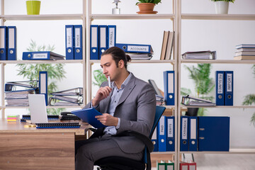 Young male employee businessman at workplace