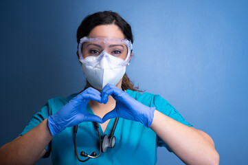 young female healthcare worker making a heart hand gesture