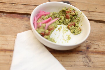 Bowl of guacamole with fresh ingredients